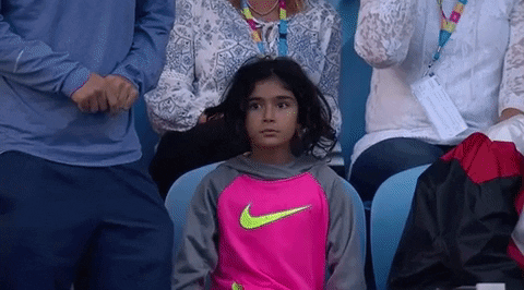 Girl standing up at sports event